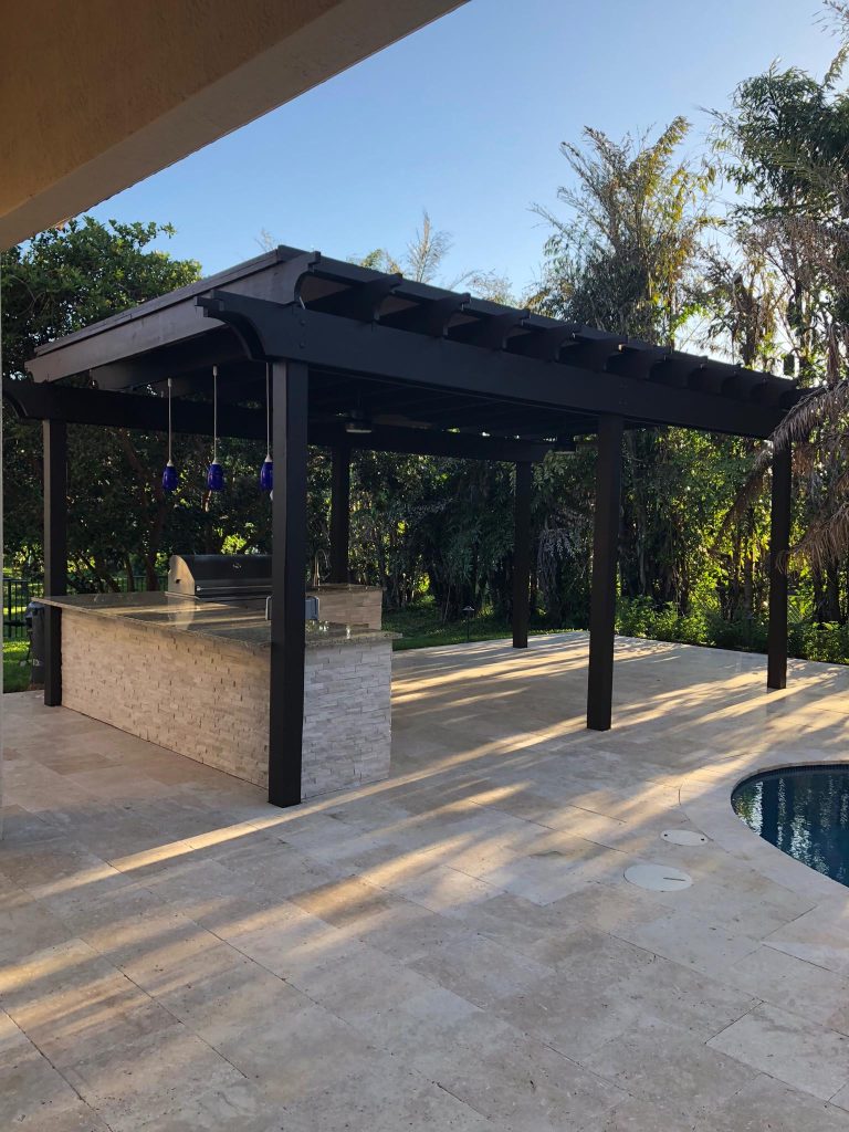 Pergola, Outdoor Kitchen Ivory TravertineInspiration for a huge modern backyard stone patio kitchen remodel in Miami with a pergola by Broward Landscape, Inc. | Outdoor Kitchens | Backyard Design | Outdoor Living Spaces | Landscape Design