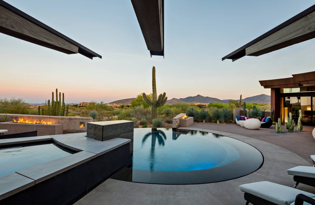 The outdoor patio and round infinity pool / Interior Designer - Tate Studio / Builder - Madison Couturier Custom Homes / Photo by Thompson Photographic