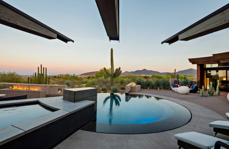The outdoor patio and round infinity pool / Interior Designer - Tate Studio / Builder - Madison Couturier Custom Homes / Photo by Thompson Photographic