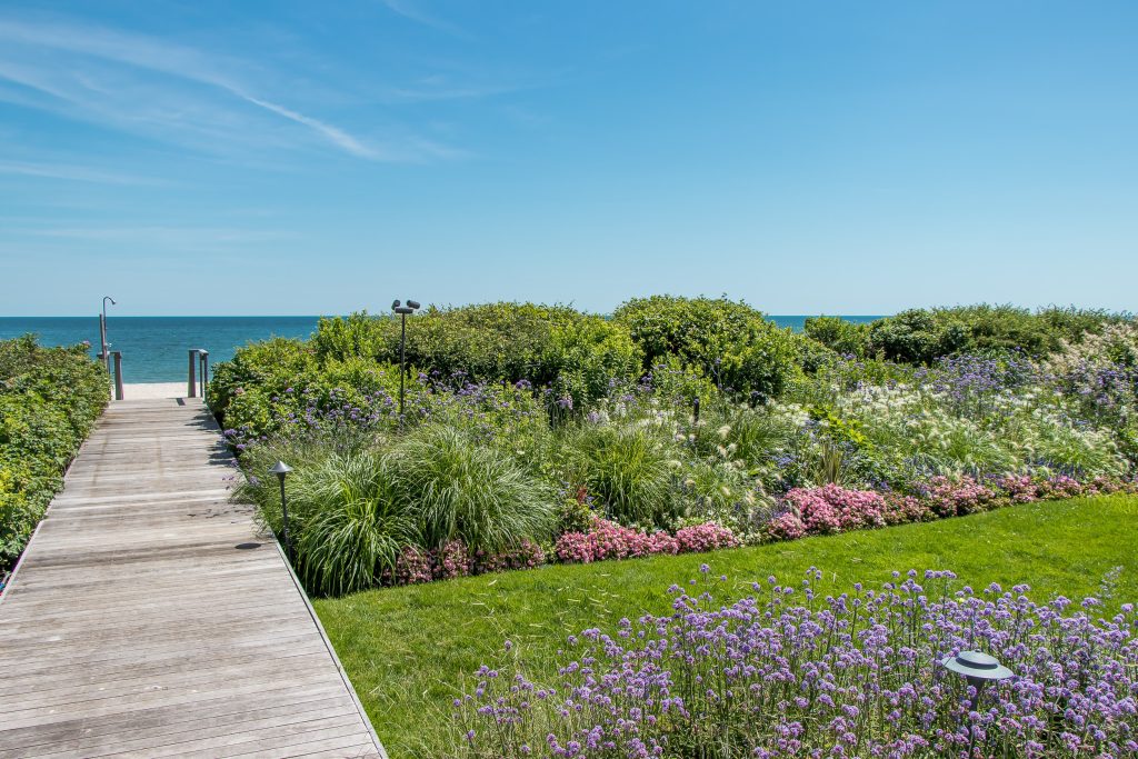 Photo of a coastal backyard garden path in New York with decking.