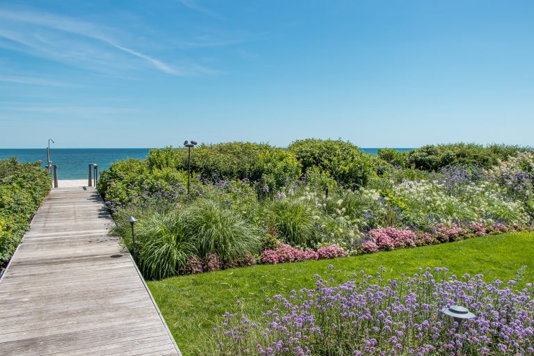 Photo of a coastal backyard garden path in New York with decking.