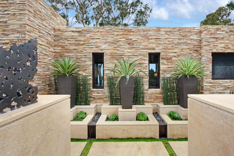 Photo of a large contemporary drought-tolerant and full sun backyard concrete paver landscaping in Orange County.