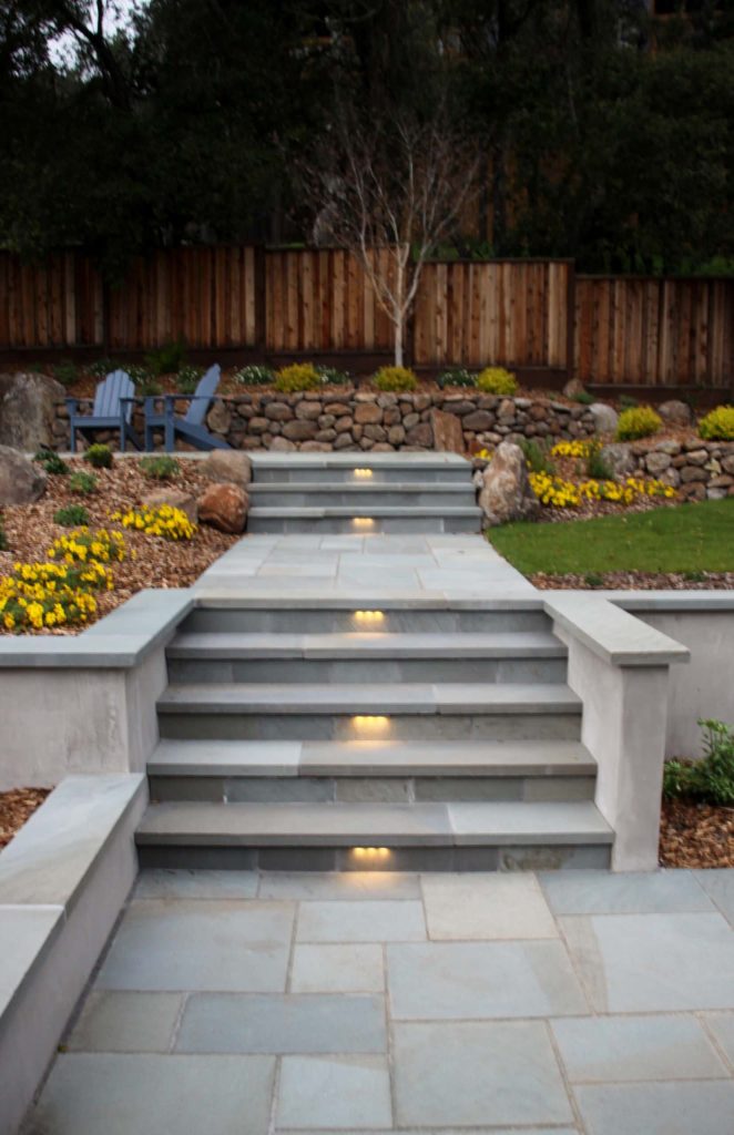 Photo of a large contemporary partial sun backyard stone retaining wall landscape in San Francisco for winter.