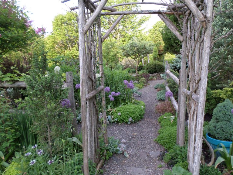 Photo of a large rustic shade backyard gravel garden path in New York.