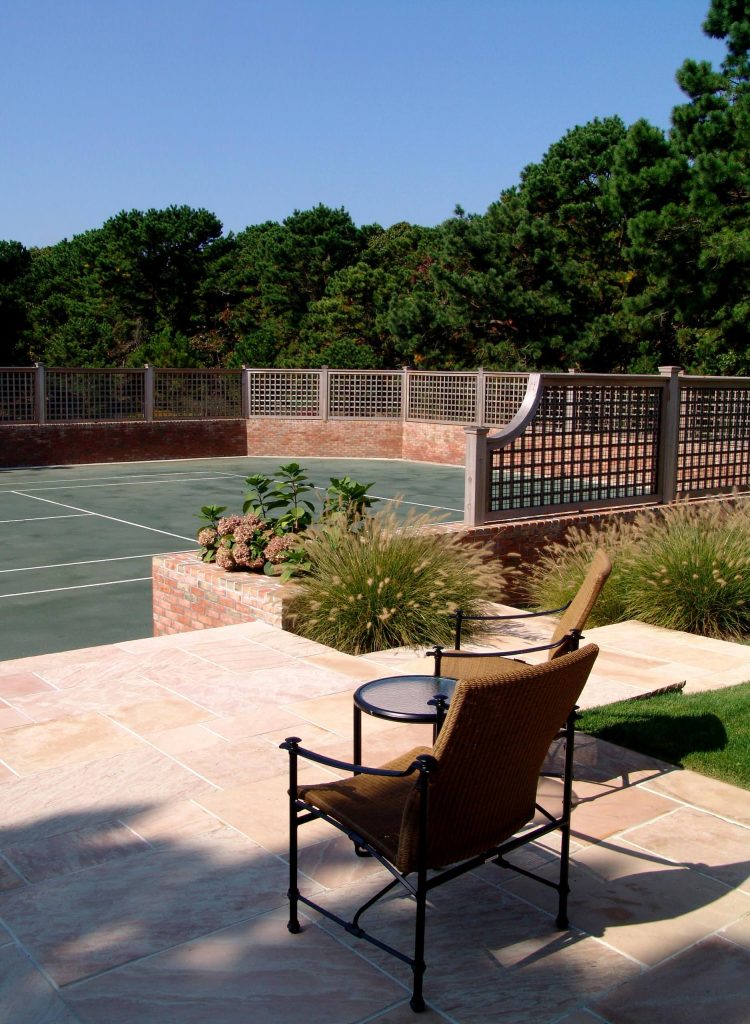 Photo of a large traditional partial sun backyard concrete paver landscaping in New York.