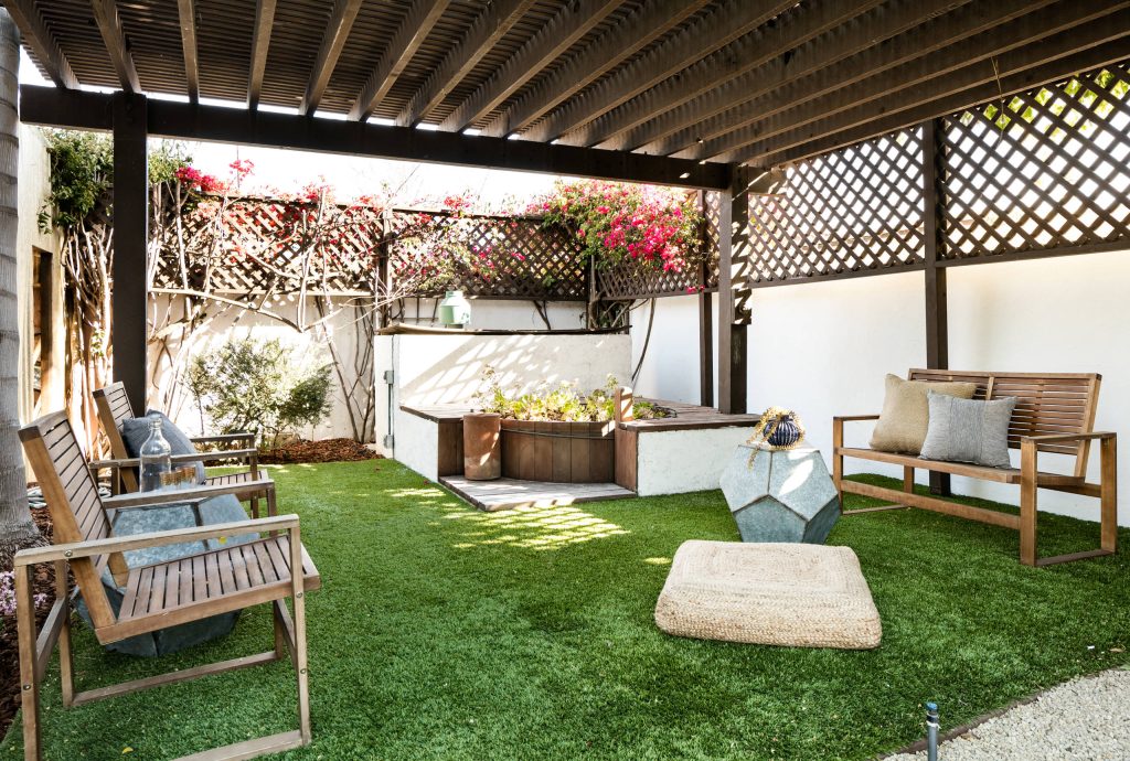 Photo of a mediterranean drought-tolerant backyard landscaping in Los Angeles with a pergola.