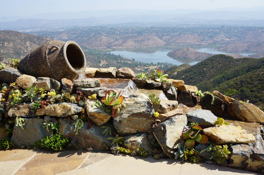 Photo of a mediterranean full sun backyard stone water fountain landscape in San Diego.