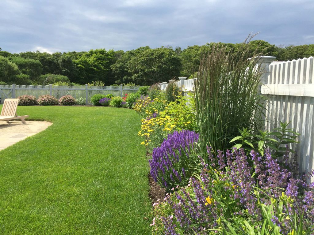 Photo of a mid-sized coastal full sun backyard stone landscaping in Boston for spring.