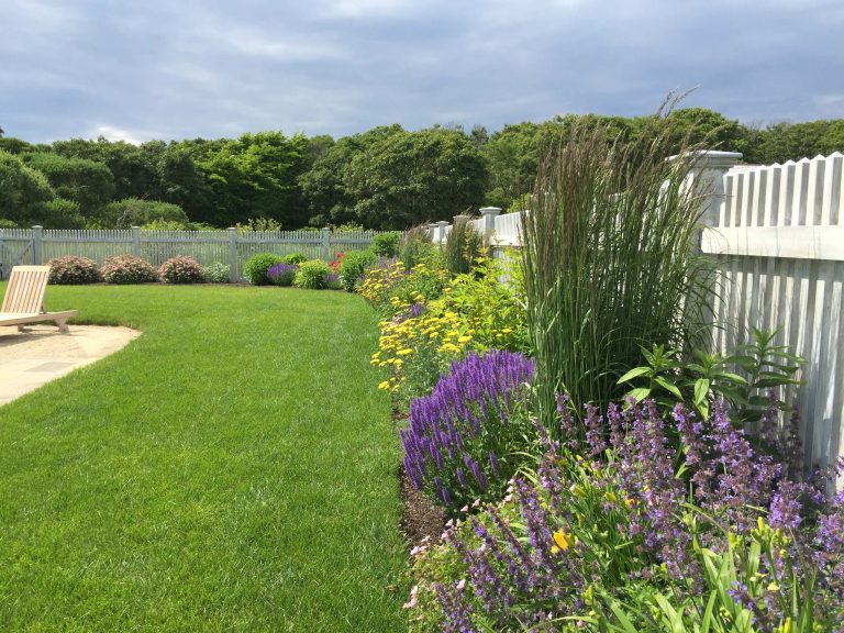Photo of a mid-sized coastal full sun backyard stone landscaping in Boston for spring.