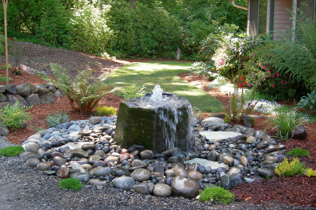 Photo of a mid-sized contemporary partial sun backyard gravel landscaping in Seattle.