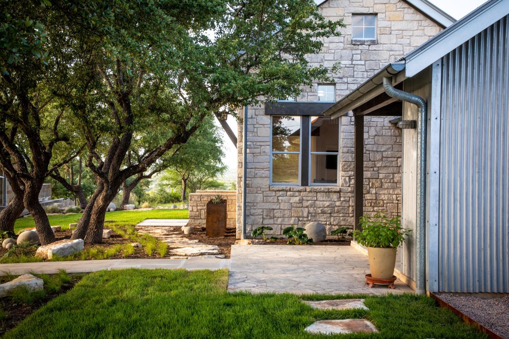 Photo of a mid-sized modern backyard concrete paver garden path in Austin.