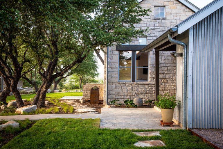 Photo of a mid-sized modern backyard concrete paver garden path in Austin.