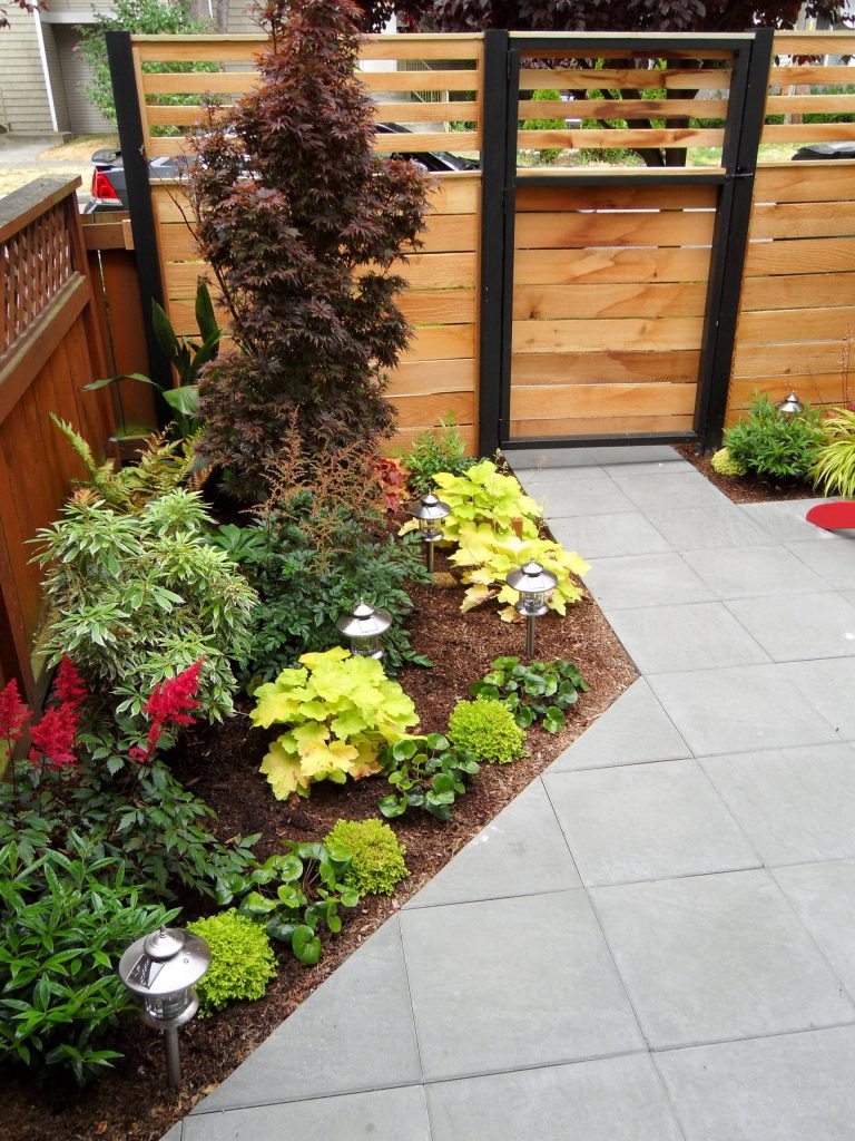 Photo of a small modern partial sun backyard concrete paver outdoor sport court in Seattle for spring.