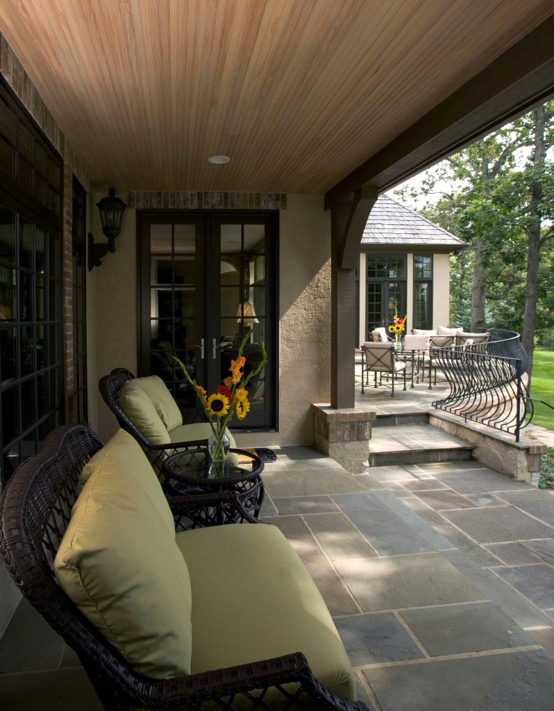Photography by Linda Oyama Bryan. http://pickellbuilders.com. Covered Porch with Cedar Beadboard Ceiling and Blue Stone Flooring, and French Doors leading out from house. by Orren Pickell Building Group | Outdoor Photos | Porch | Landscaping | Landscape Design | Outdoor Living Space | Porch Design Ideas | Outdoor Living Space Ideas | Backyard Design