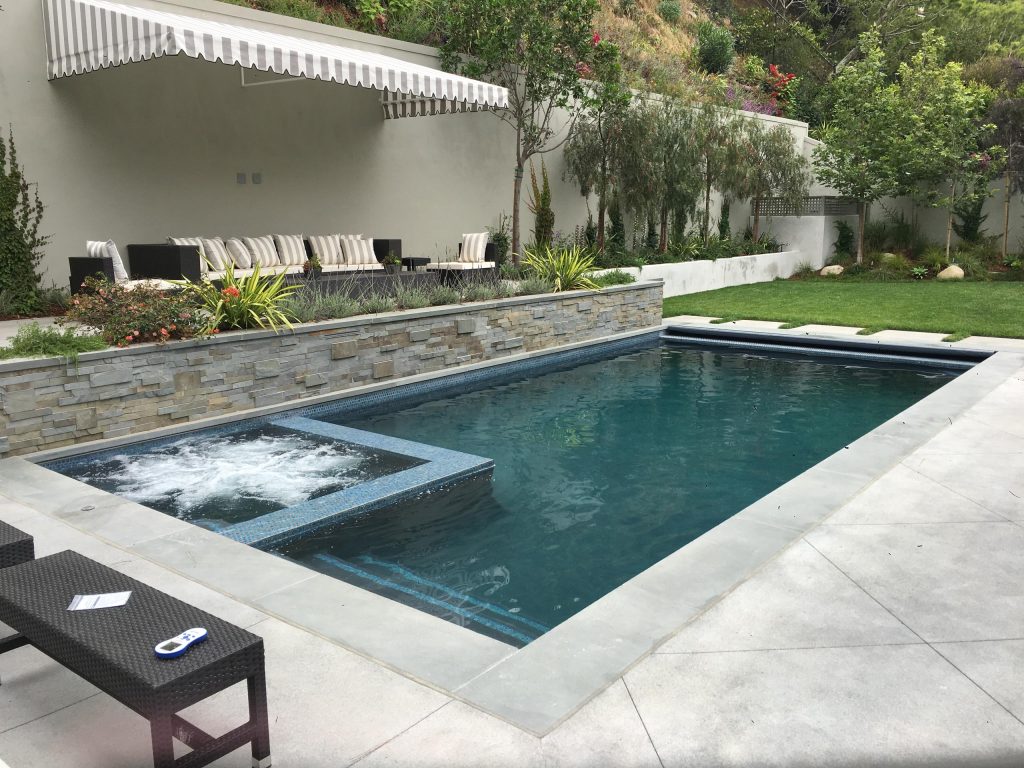 Pool 35'X14' with 6'X6' spa, gray plaster finish, 1''X1'' tile around water line and steps.
