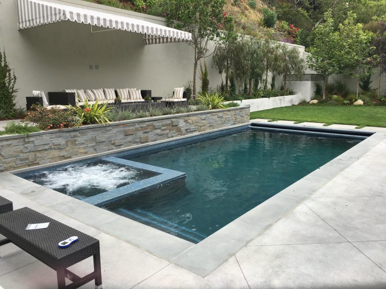 Pool 35'X14' with 6'X6' spa, gray plaster finish, 1''X1'' tile around water line and steps.