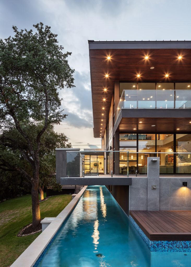 Pool - contemporary l-shaped lap pool idea in Austin with decking