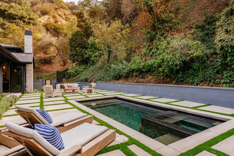 Pool - cottage backyard concrete paver and rectangular natural pool idea in Los Angeles