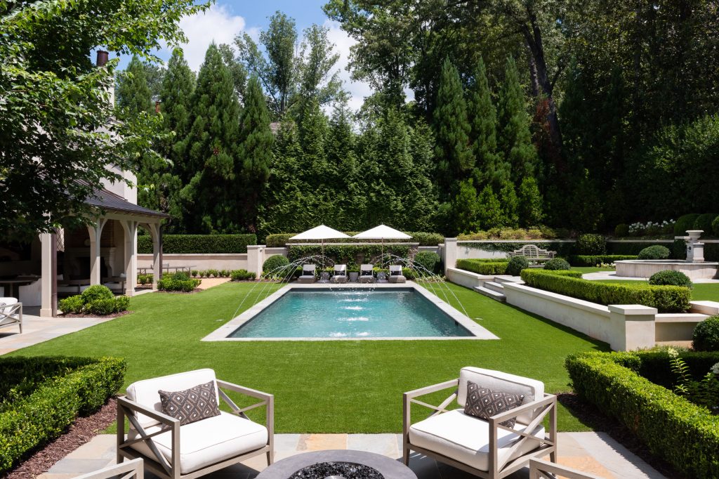 Pool fountain - huge traditional backyard stone and rectangular lap pool fountain idea in Atlanta