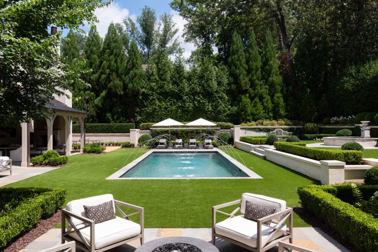 Pool fountain - huge traditional backyard stone and rectangular lap pool fountain idea in Atlanta