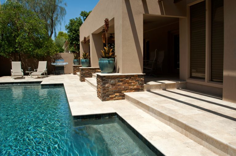 Pool fountain - large contemporary backyard stone and custom-shaped lap pool fountain idea in Phoenix
