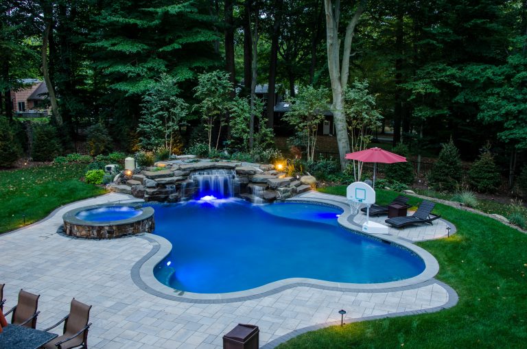 Pool fountain - large transitional backyard stone and custom-shaped natural pool fountain idea in New York
