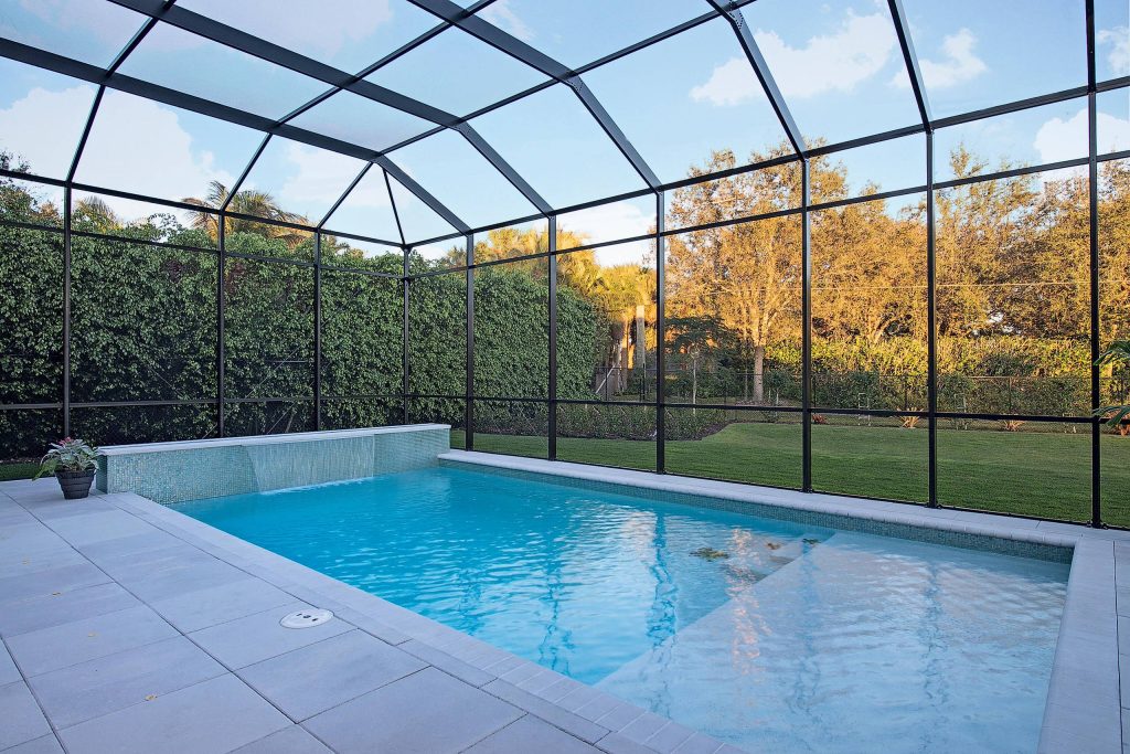 Pool fountain - large tropical backyard concrete paver and rectangular pool fountain idea in Miami