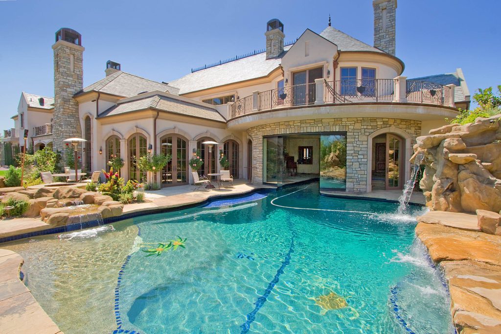 Pool fountain - mediterranean custom-shaped pool fountain idea in Los Angeles