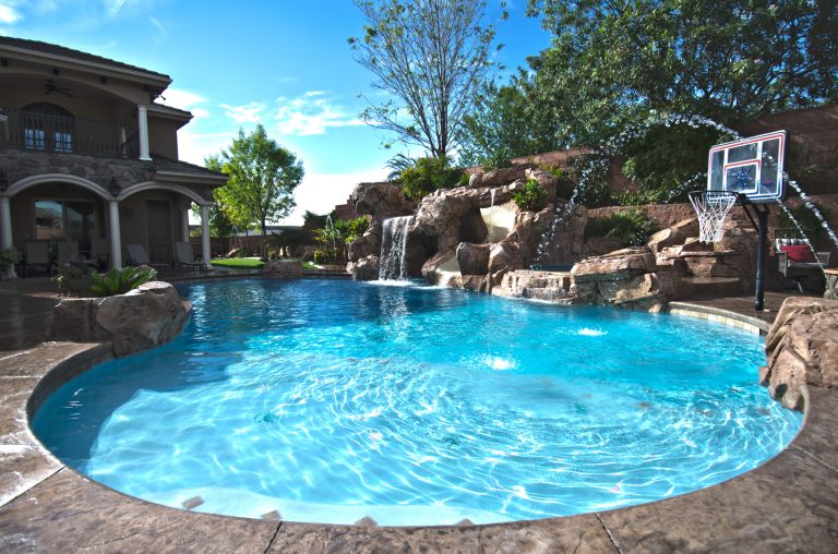 Pool fountain - mid-sized backyard stone and custom-shaped natural pool fountain idea in Las Vegas