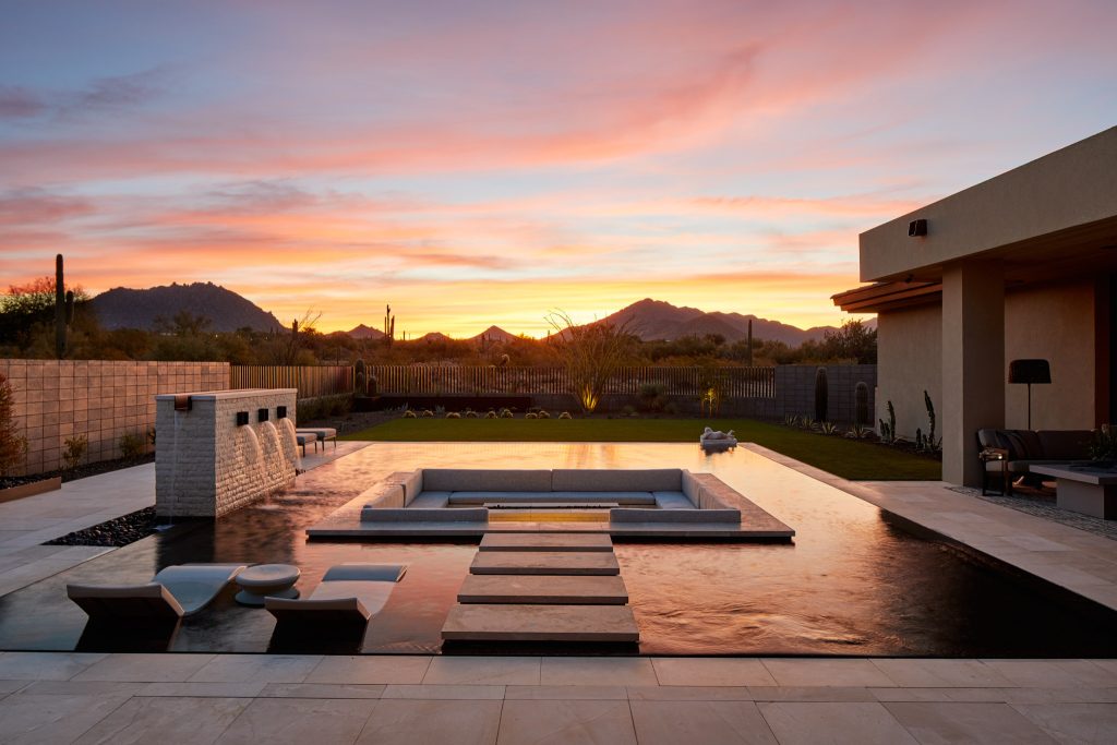 Pool fountain - mid-sized backyard tile and rectangular infinity pool fountain idea in Phoenix