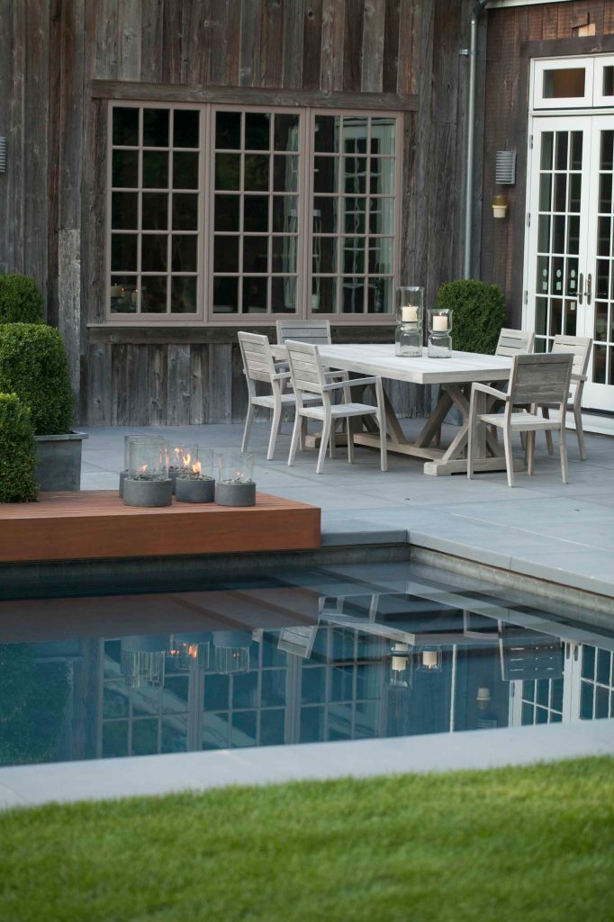 Pool fountain - mid-sized contemporary backyard concrete and rectangular lap pool fountain idea in New York
