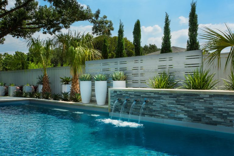 Pool fountain - mid-sized modern backyard rectangular pool fountain idea in Dallas