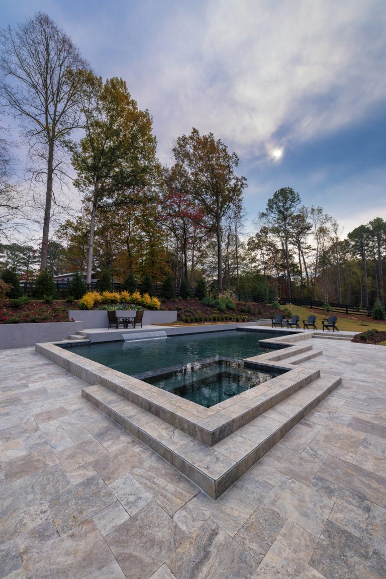 Pool fountain - mid-sized modern backyard stone pool fountain idea in Atlanta