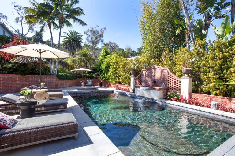 Pool fountain - traditional backyard concrete and rectangular lap pool fountain idea in San Diego