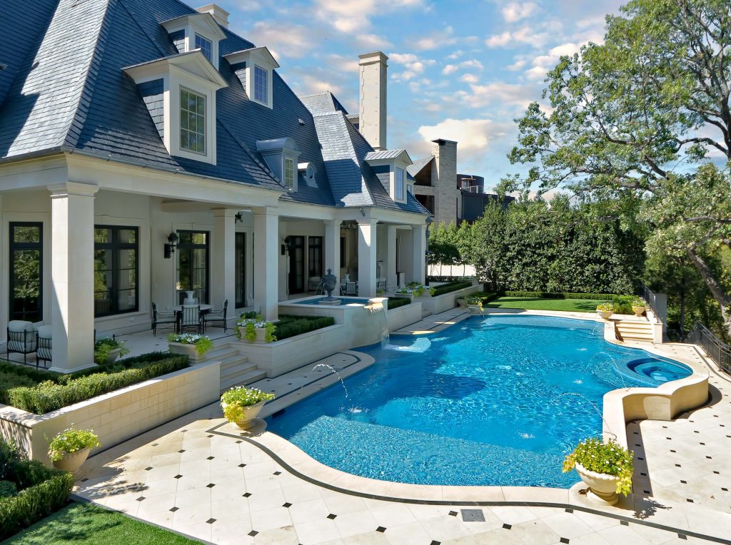Pool fountain - traditional custom-shaped pool fountain idea in Dallas