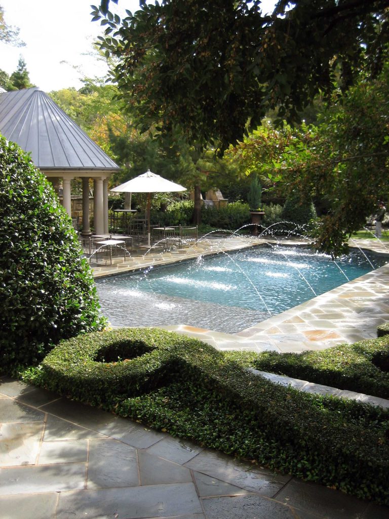 Pool fountain - traditional stone and rectangular pool fountain idea in Dallas