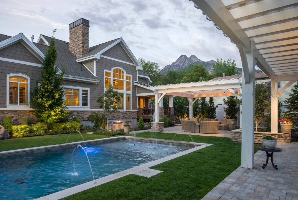 Pool fountain - transitional backyard concrete paver and rectangular pool fountain idea in Salt Lake City