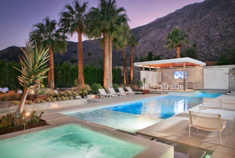 Pool house - large 1960s backyard concrete and rectangular infinity pool house idea in San Diego
