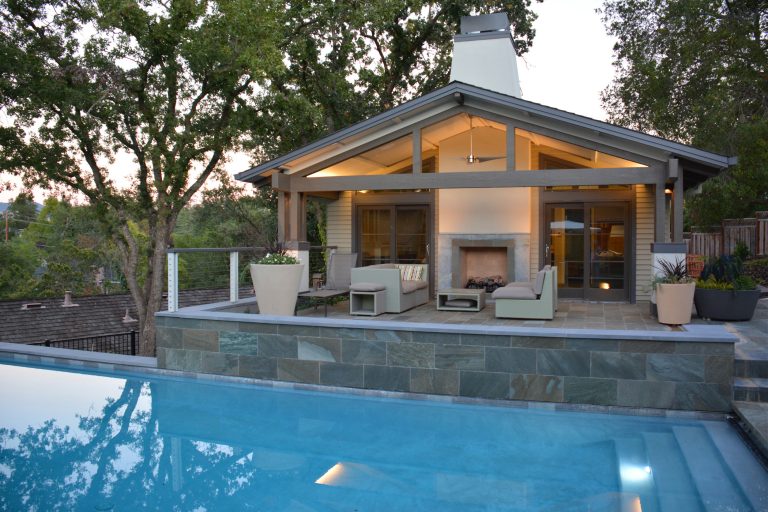 Pool house - large contemporary backyard stone and rectangular lap pool house idea in San Francisco