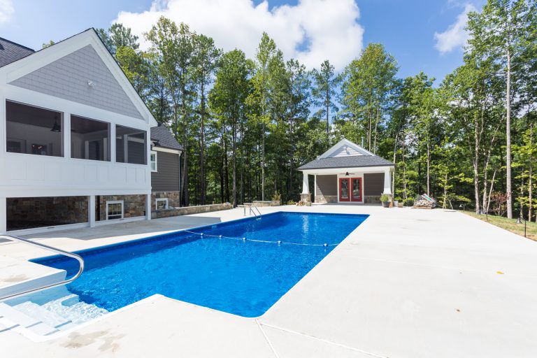 Pool house - large craftsman backyard concrete and rectangular lap pool house idea in DC Metro