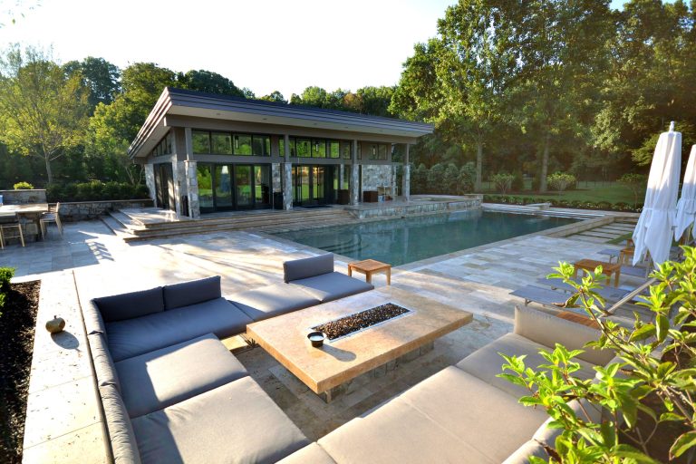 Pool house - large modern backyard stone and rectangular lap pool house idea in DC Metro