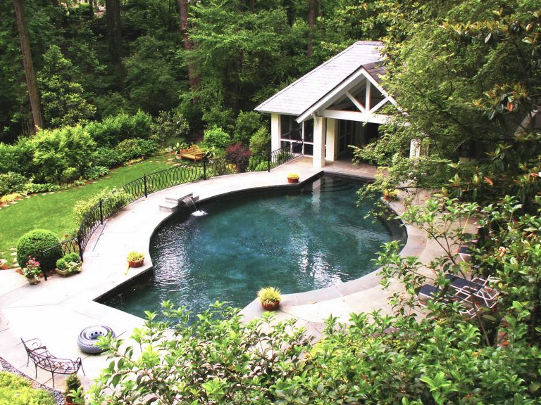 Pool house - large traditional backyard concrete and custom-shaped pool house idea in Atlanta