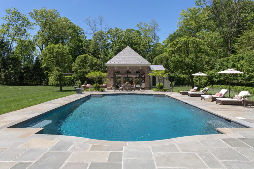 Pool house - large traditional backyard tile and rectangular lap pool house idea in New York