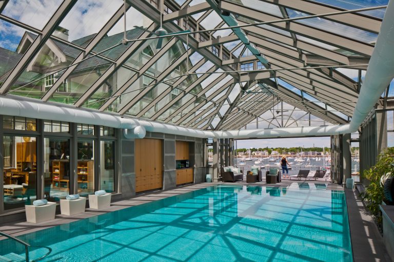 Pool house - large traditional indoor concrete and rectangular pool house idea in Boston