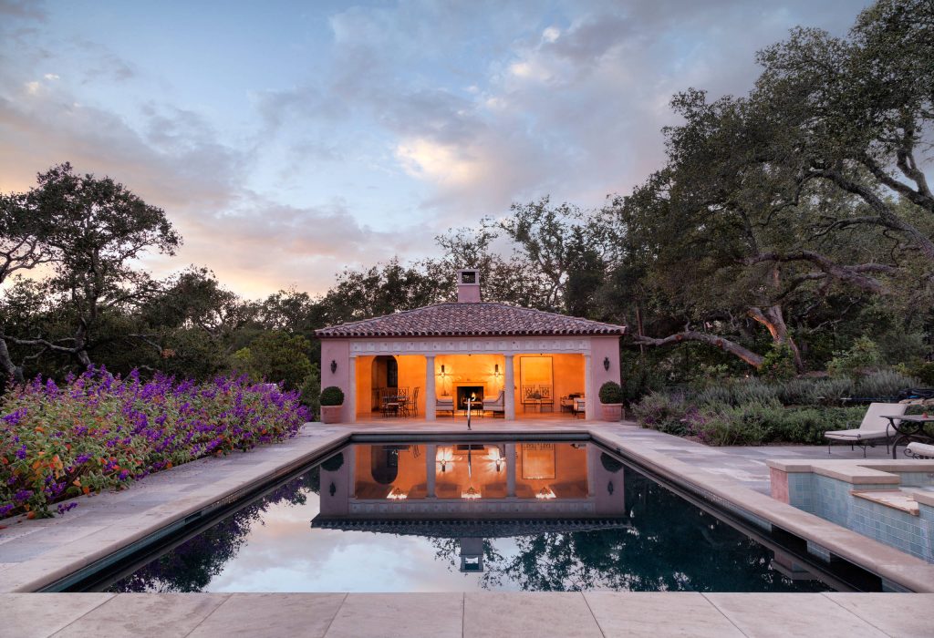 Pool house - mediterranean backyard stone and rectangular pool house idea in Los Angeles