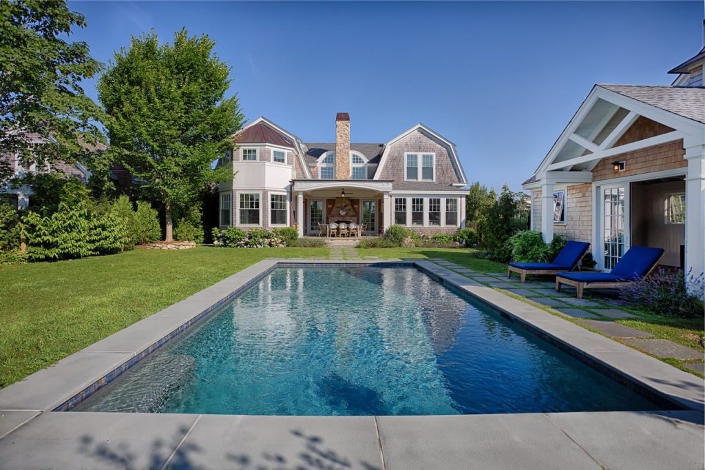 Pool house - mid-sized coastal backyard concrete paver and rectangular lap pool house idea in Boston