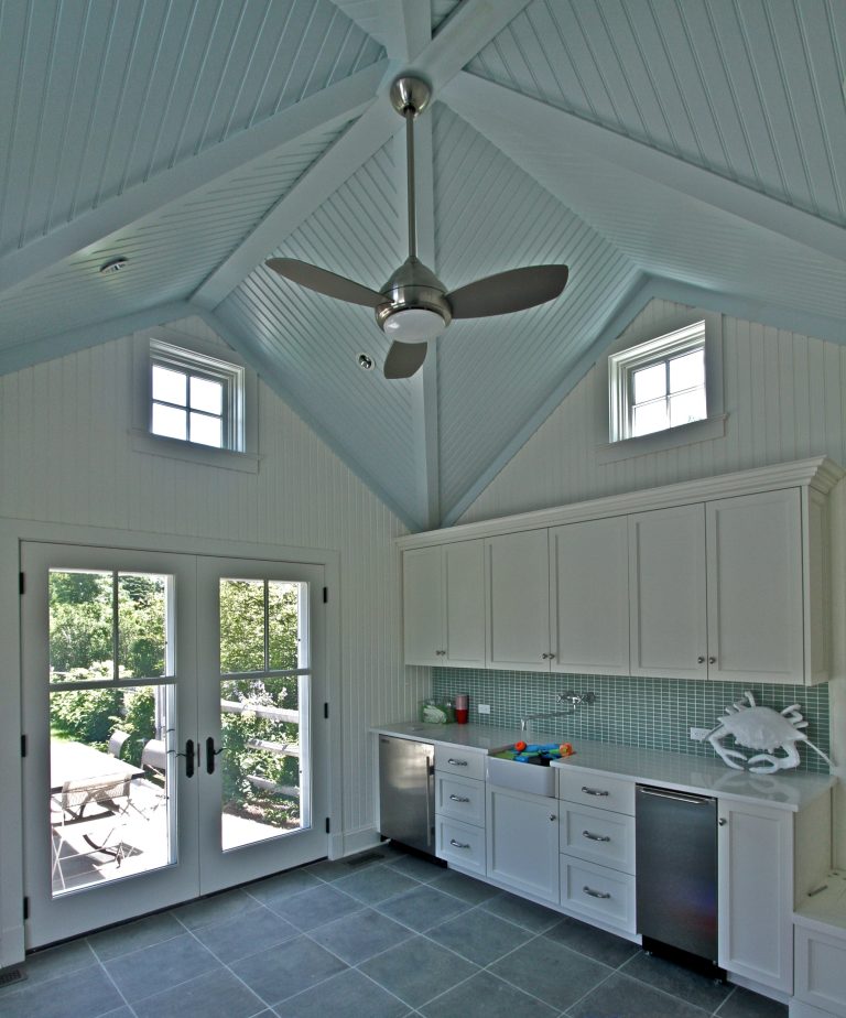 Pool house - mid-sized transitional backyard tile pool house idea in New York