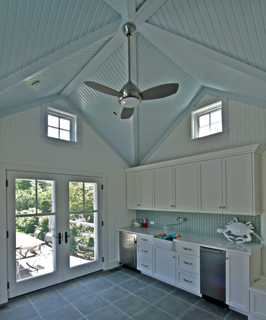 Pool house - mid-sized transitional backyard tile pool house idea in New York