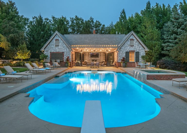 Pool house - transitional custom-shaped pool house idea in Omaha