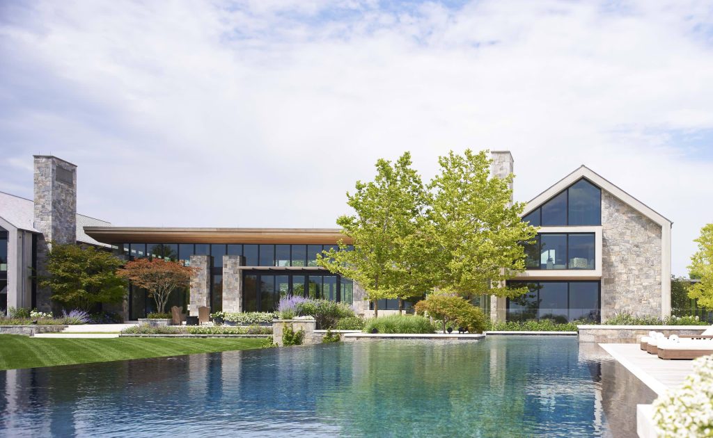 Pool - huge modern backyard custom-shaped infinity pool idea in New York